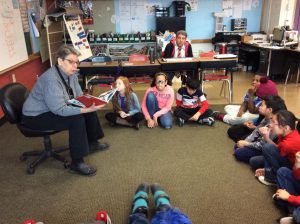 Central admin staff reads to children at SA