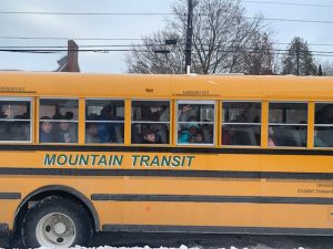 students riding school bus