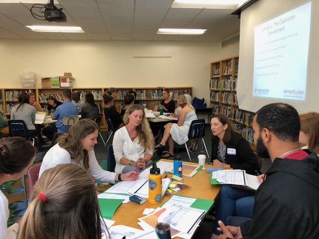 Teachers working on professional learning together around a table