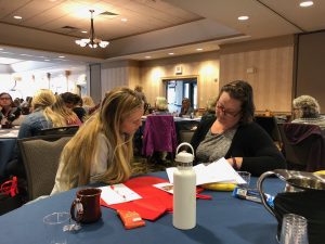 Two women reading at a conference table