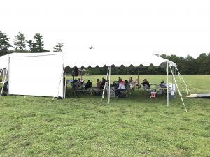 BSD Employees Sitting Under Large Event Tent