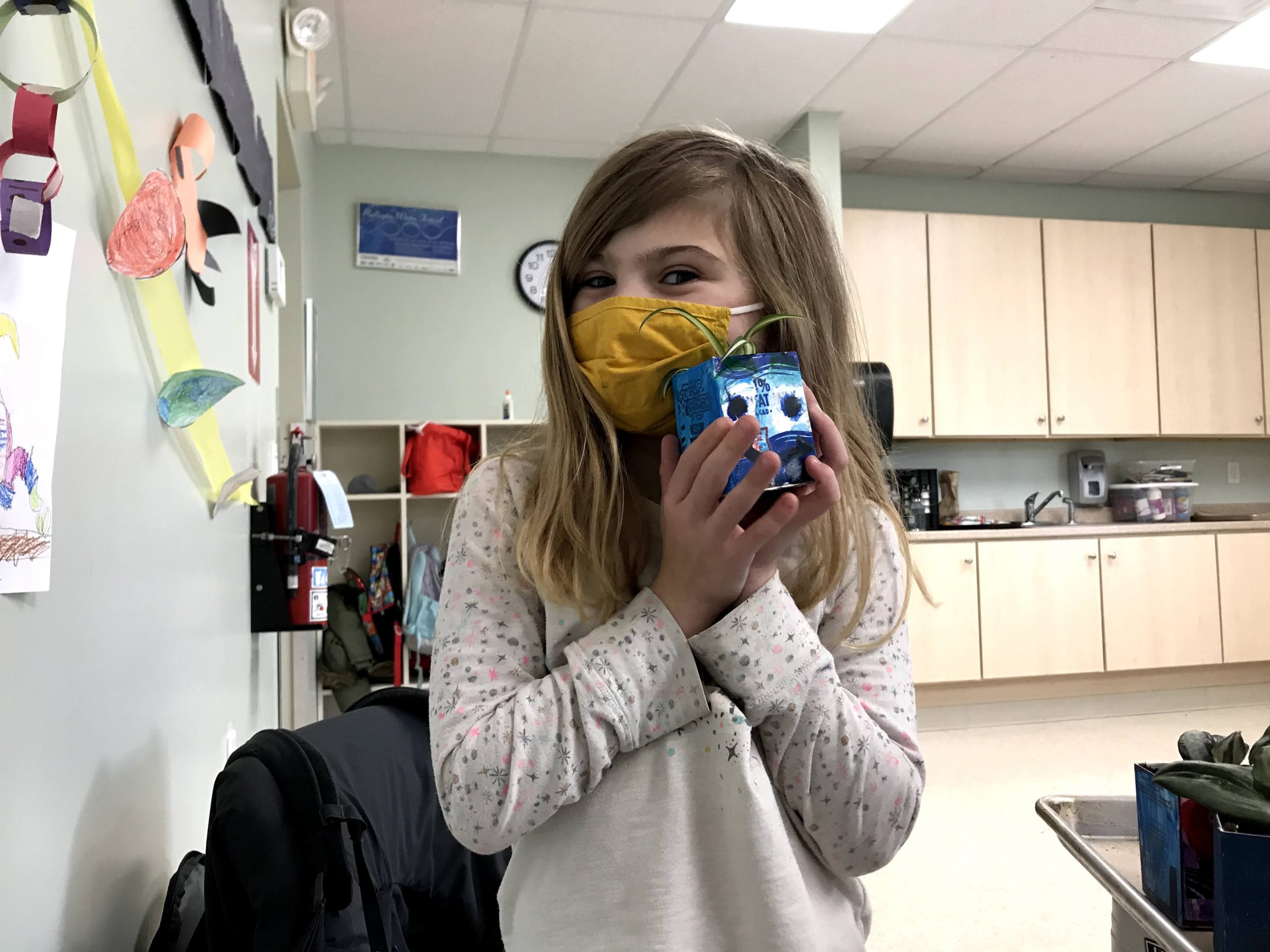 Student with plant Student with plant