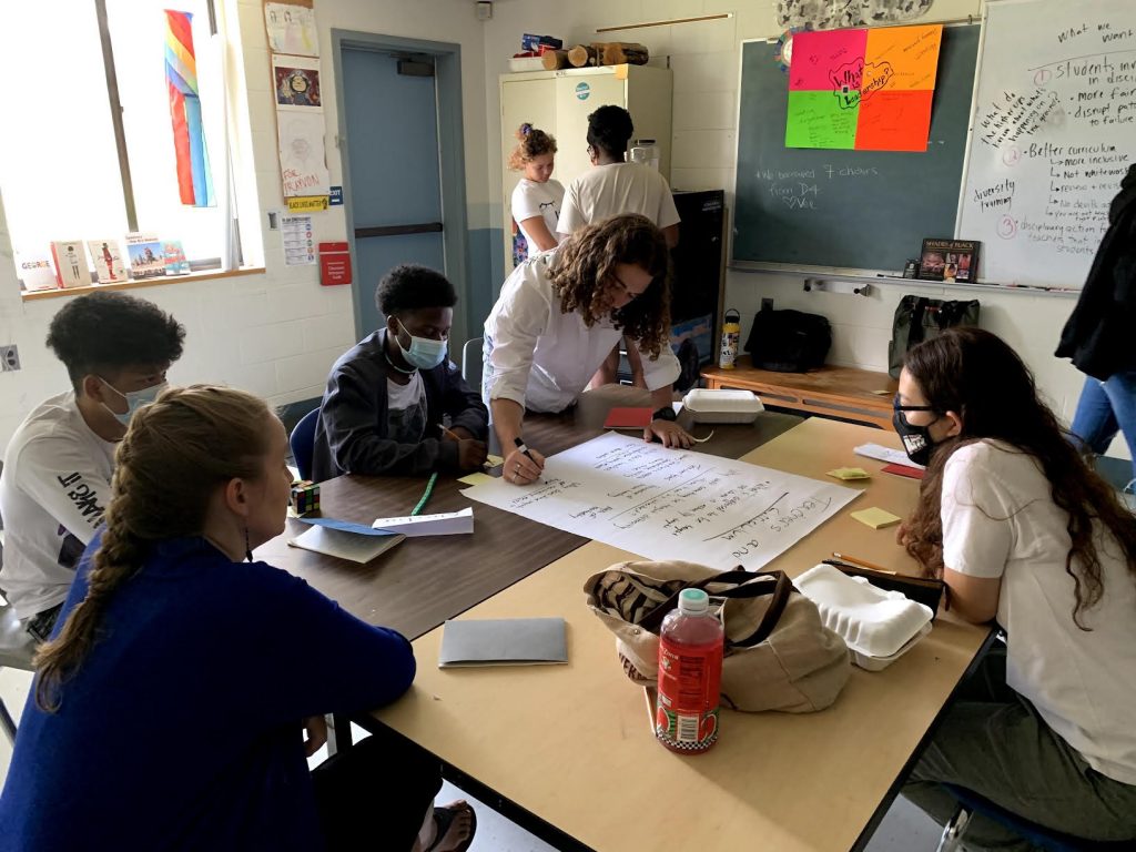 Students work together to create a poster