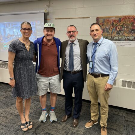 Chair Wool, Jason Raymond, Superintendent Flanagan, and Director Reed posing for a photo