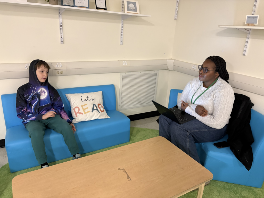 photo of a high school girl interviewing a fifth grader