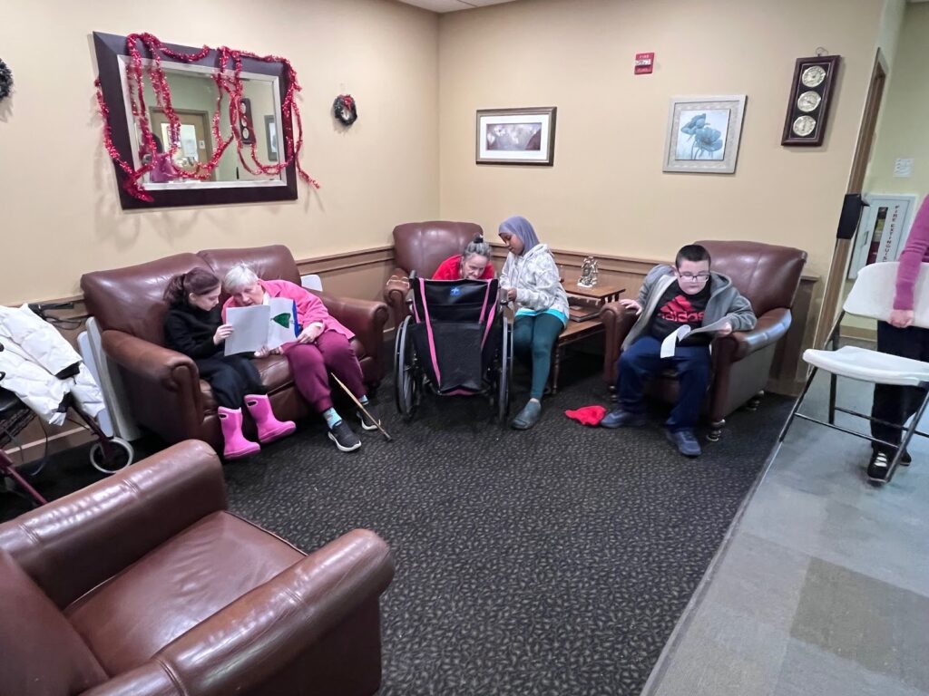 elementary students singing to seniors in a nursing home