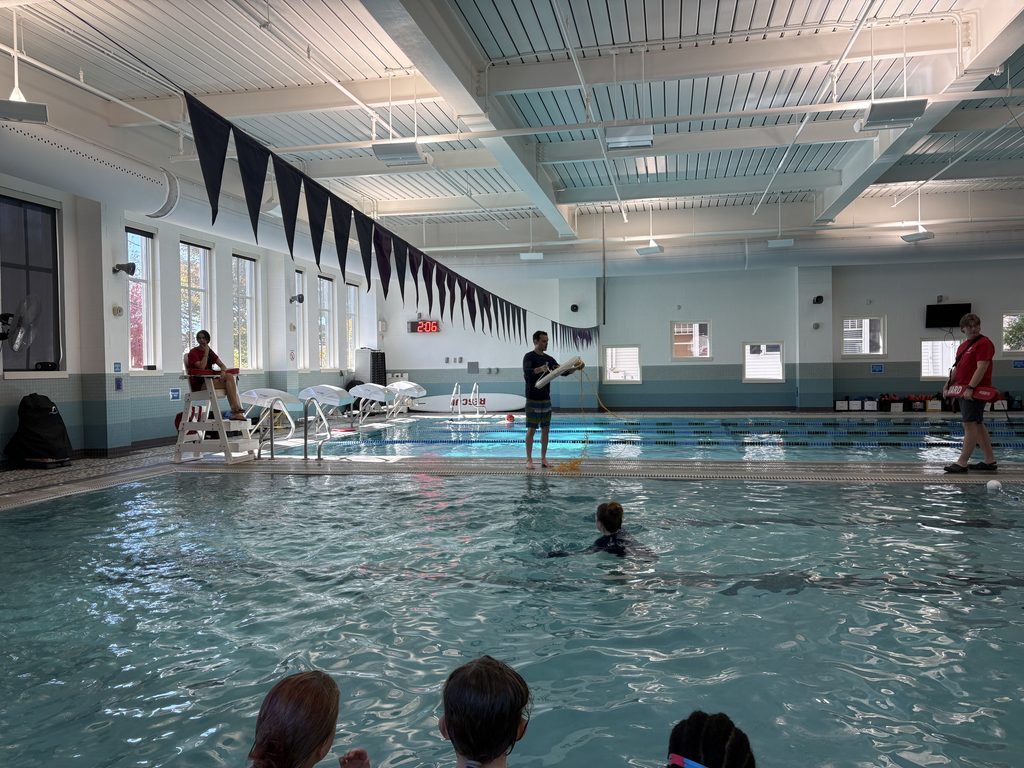 a YMCA instructor throwing a life preserver