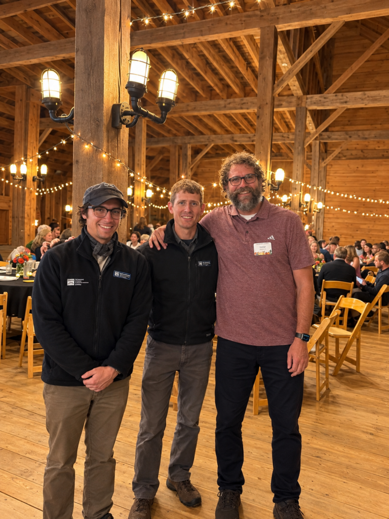 Simon posing with VYCC staff at an event honoring him